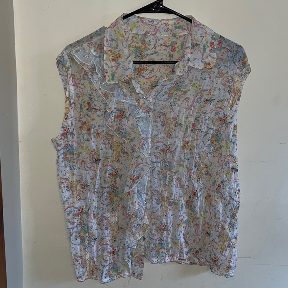 White floral blouse with lace detailing near buttons